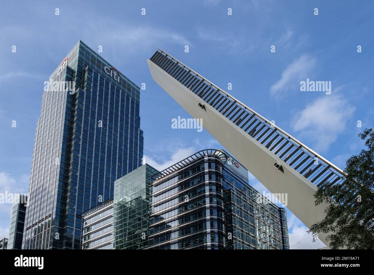 Water Street Bridge opened with tall buildings in background including Citigroup Centre and HSBC, Canary Wharf, London, England. Stock Photo