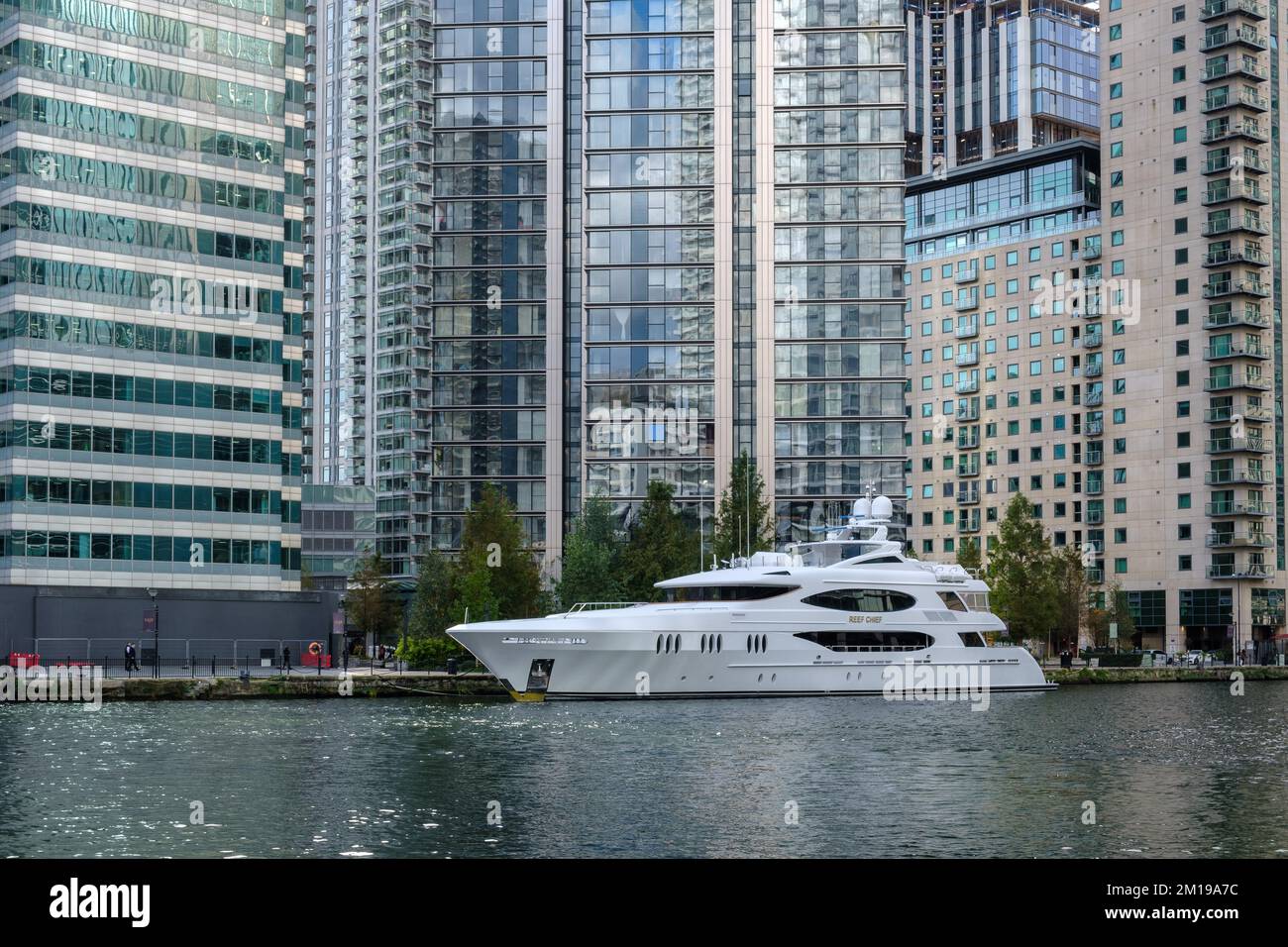 Yacht Reef Chief docked, at the southern end of Bellmouth Passage in front of Deutsche Bank and other high-rise buildings in Canary Wharf, London, UK. Stock Photo