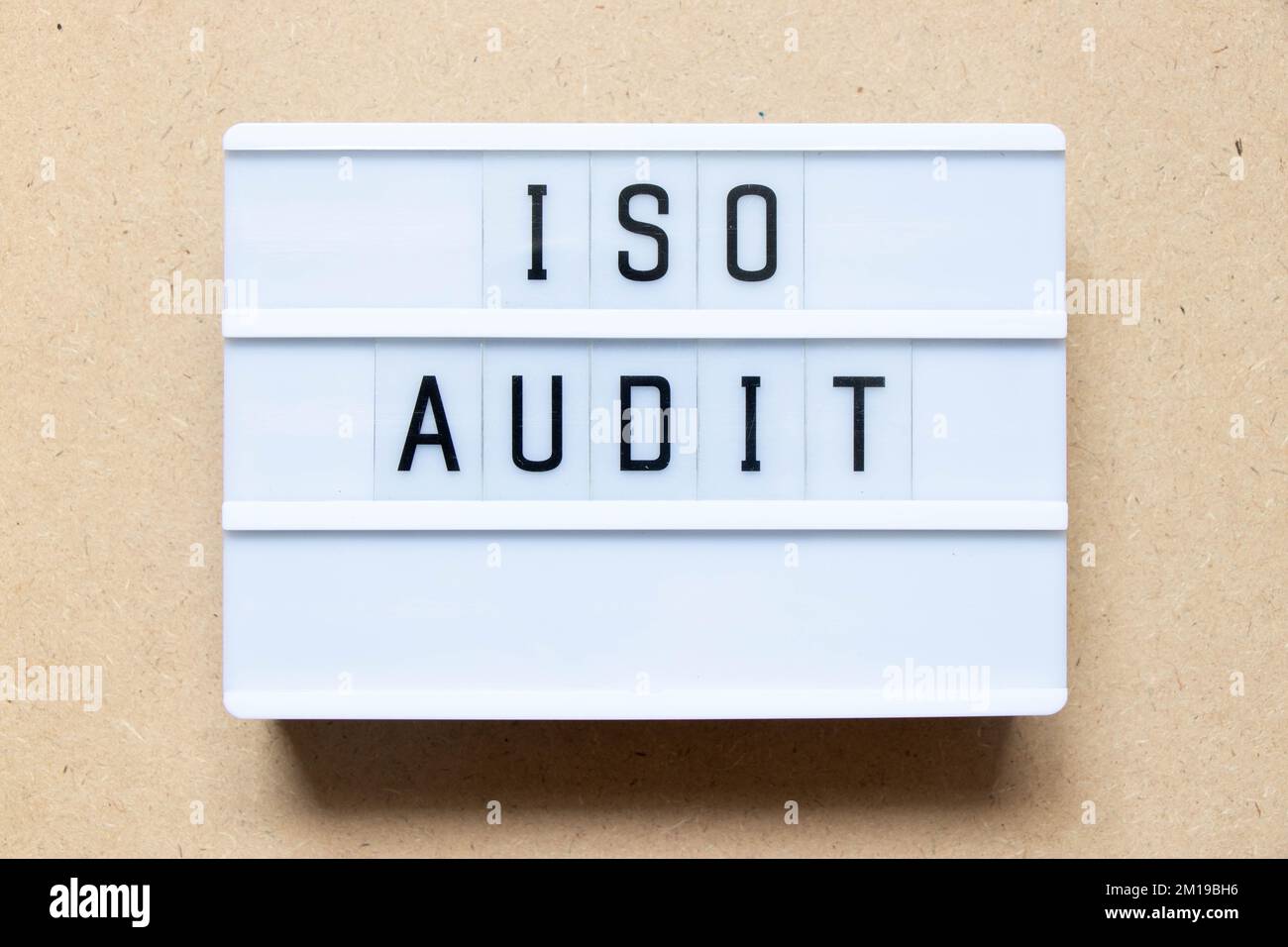 Lightbox with word ISO audit on wood background Stock Photo