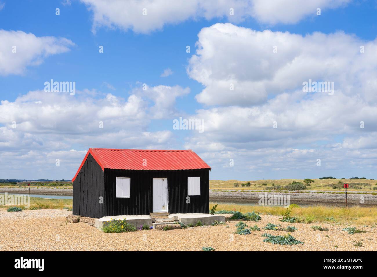 Rye Harbour Nature Reserve Hut with red roof Red Roofed Hut and blue sky and clouds Rye Harbour Rye East Sussex England UK GB Europe Stock Photo