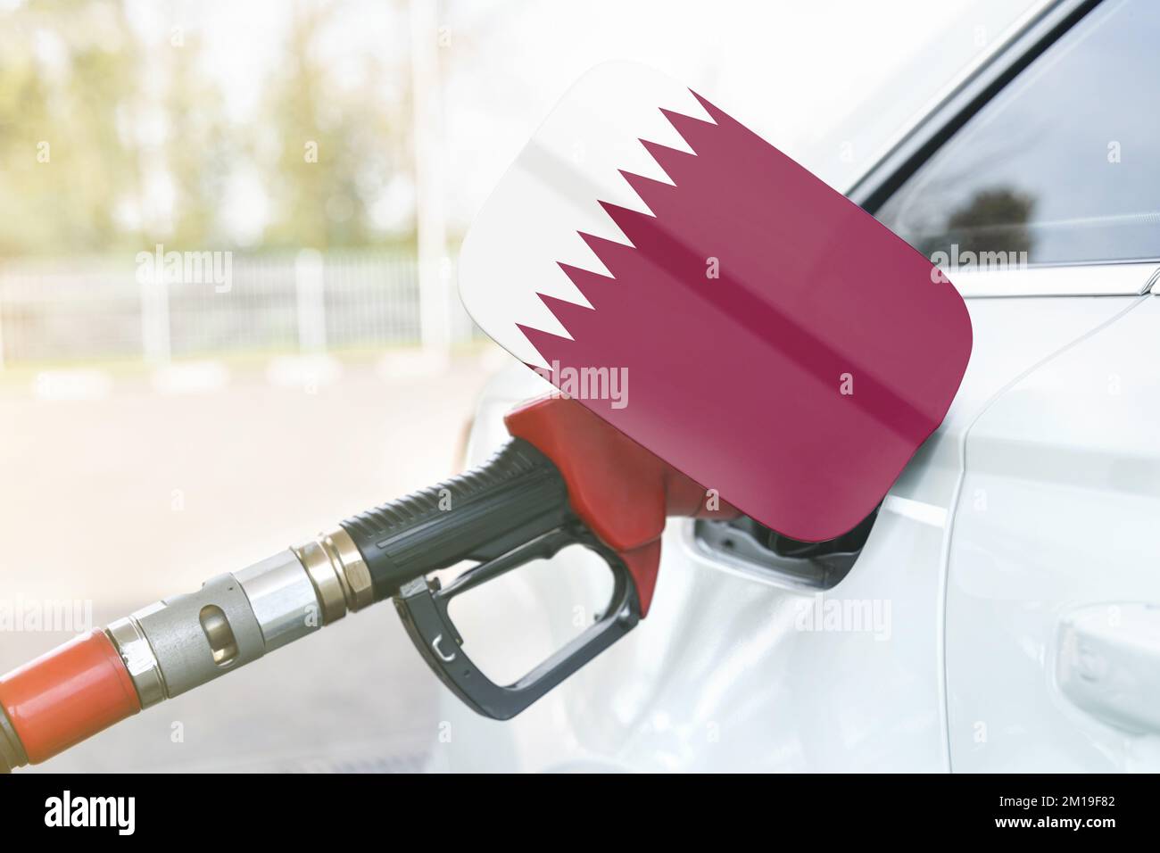 Energy and economy concept. Flag of Qatar on the car's fuel filler flap