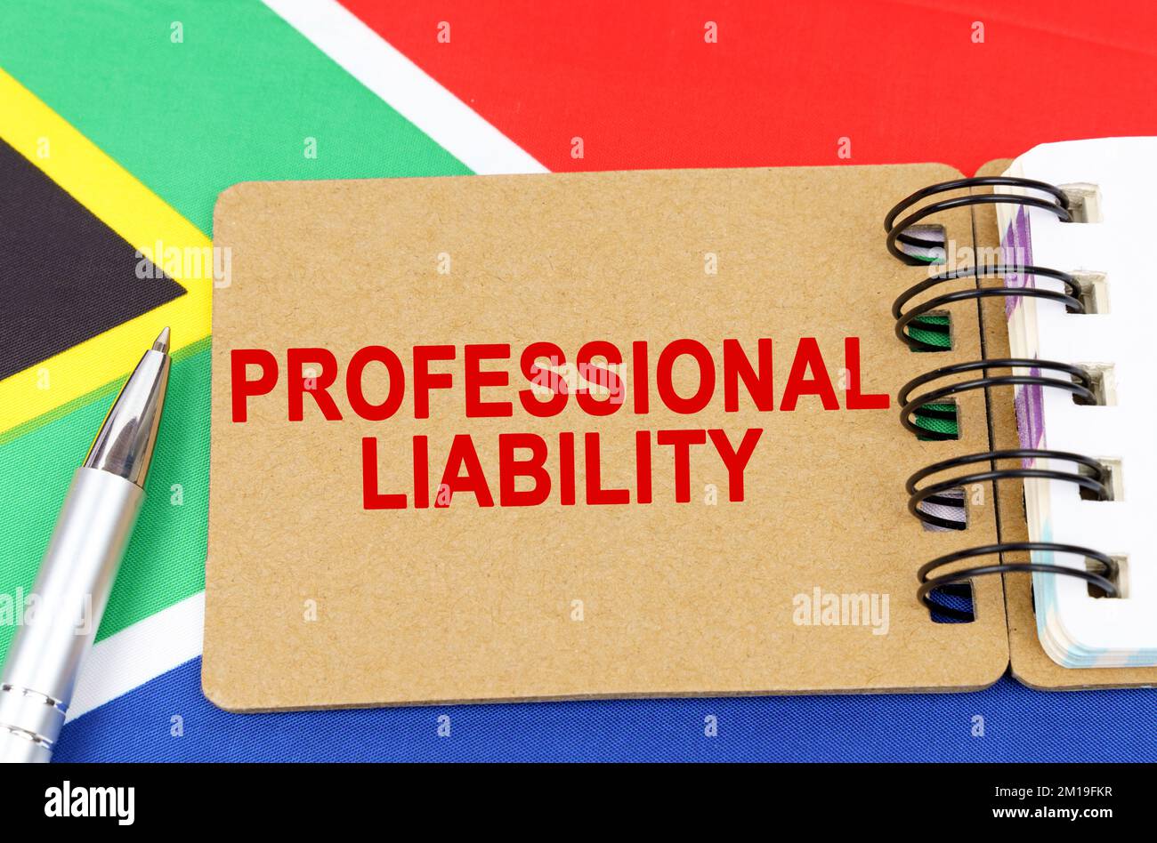Law and justice concept. Against the background of the flag of South Africa lies a notebook with the inscription - PROFESSIONAL LIABILITY Stock Photo