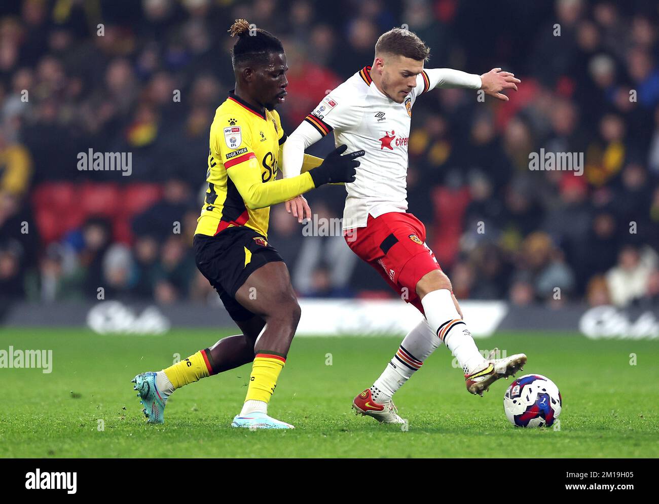 Hull City's Regan Slater (right) and Watford's Tom Dele-Bashiru battle for the ball during the Sky Bet Championship match at Vicarage Road, Watford. Picture date: Sunday December 11, 2022. Stock Photo