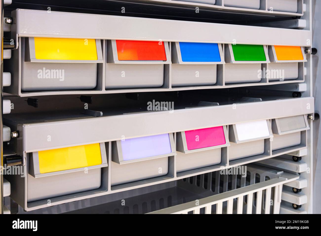 rows of multicolored plastic boxes for components Stock Photo