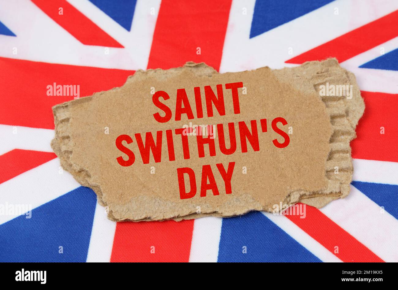 Holidays of the UK. Against the background of the flag of Great Britain lies cardboard with the inscription - Saint Swithuns Day Stock Photo
