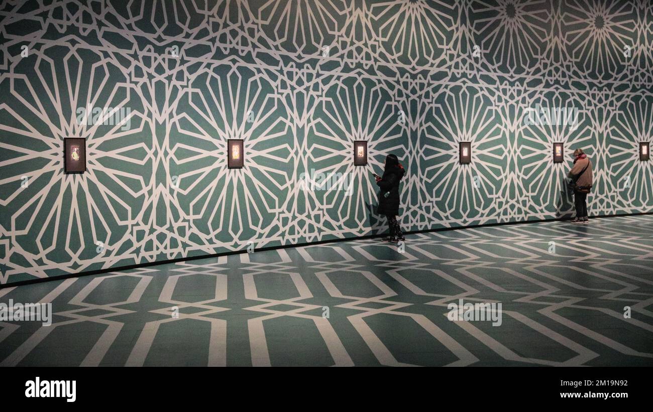 London, UK. 11th Dec, 2022. Visitors look at the works on display. The