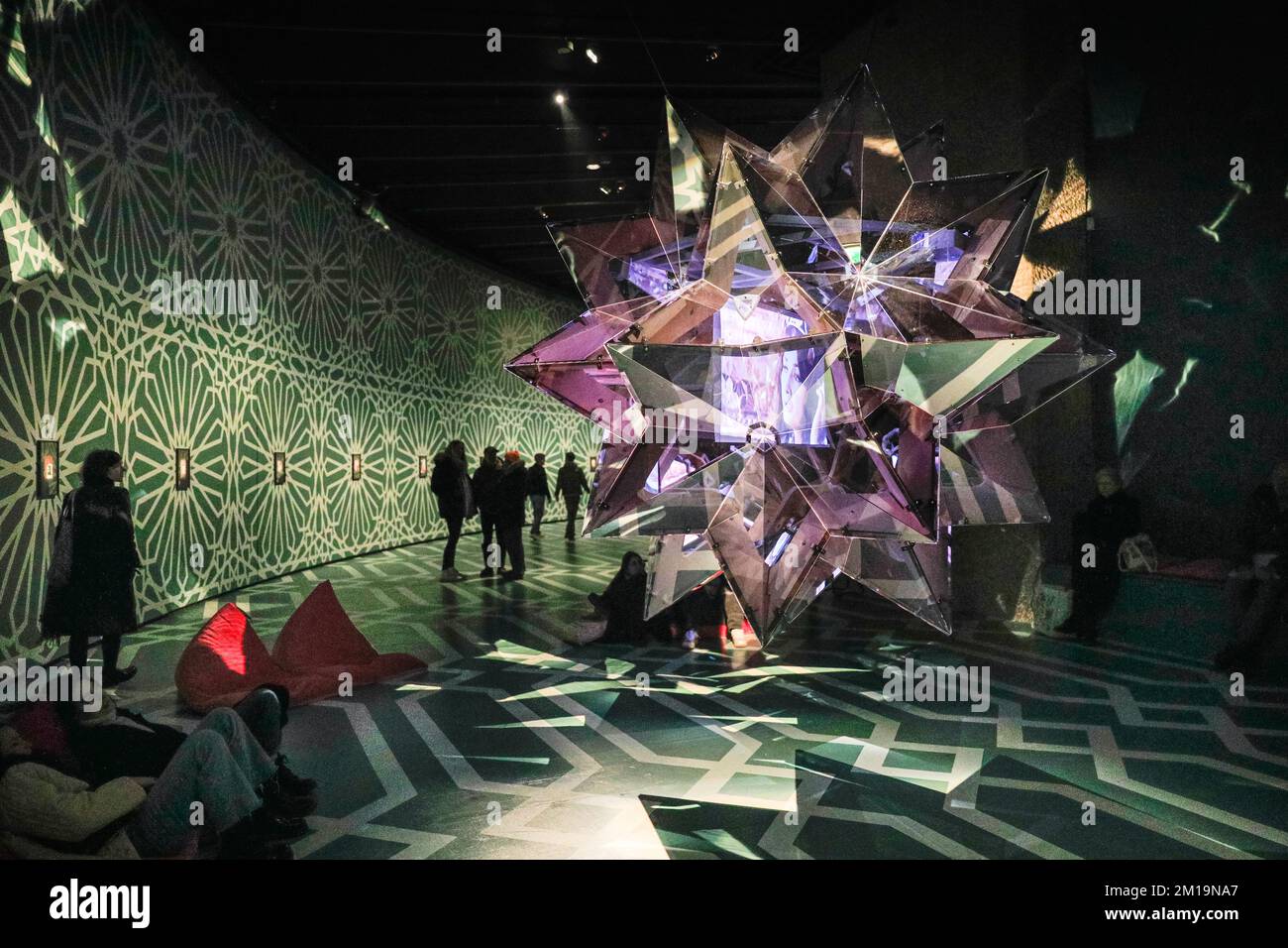 London, UK. 11th Dec, 2022. Visitors look at a starshaped extravagant