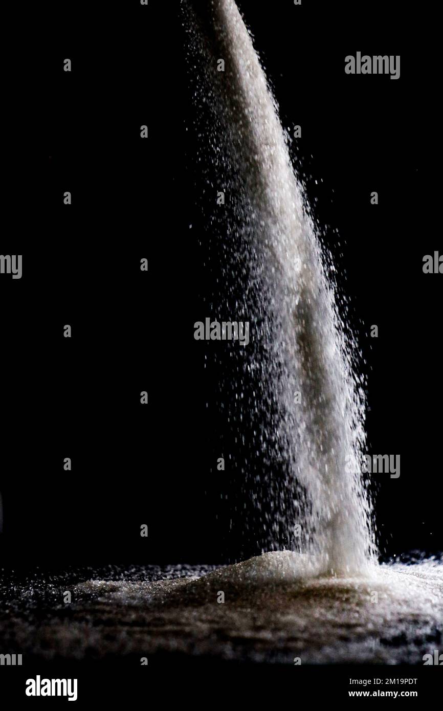 Sugar spill flow low light Stock Photo Alamy
