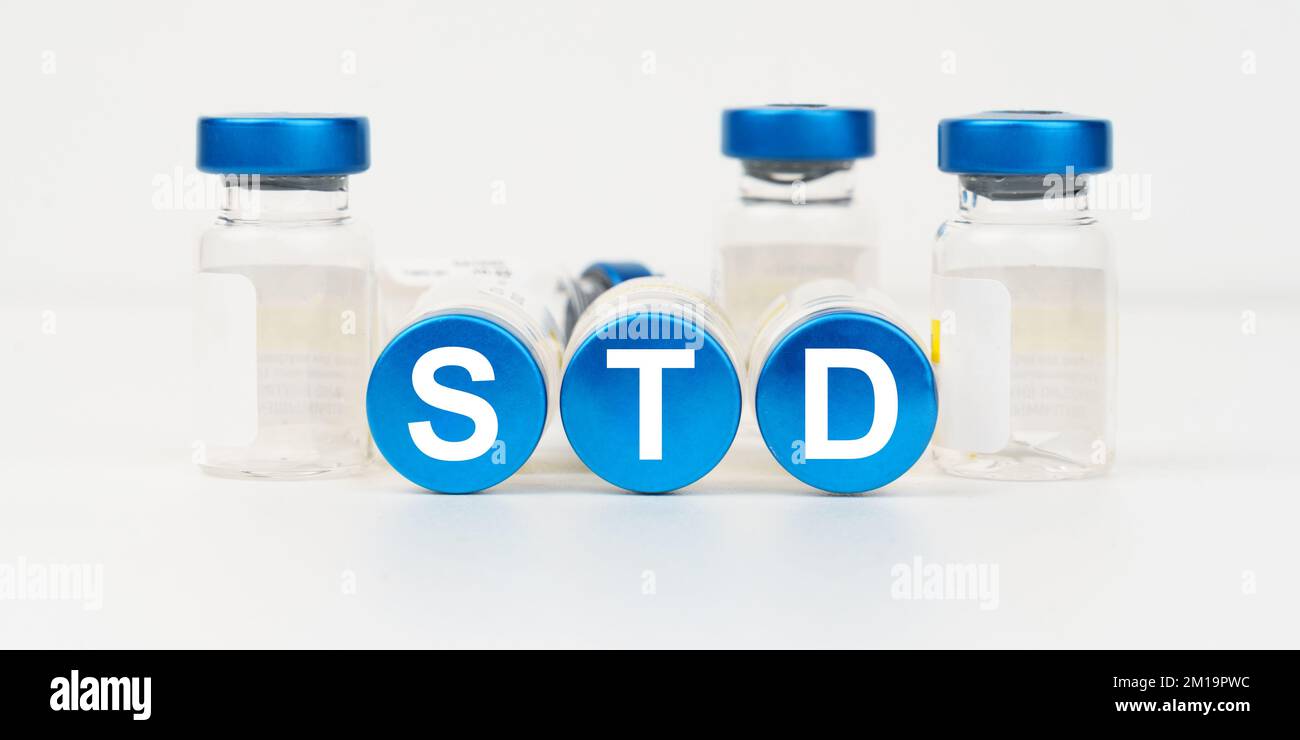 Medicine and health concept. On the blue roofs of the injections it says -STD Stock Photo