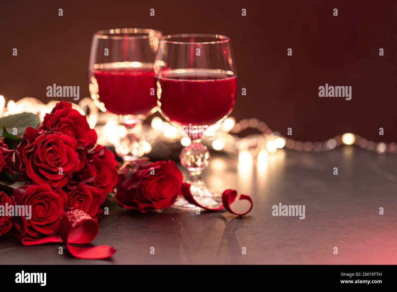 Romantic background with glasses of wine and a bouquet of roses Stock ...