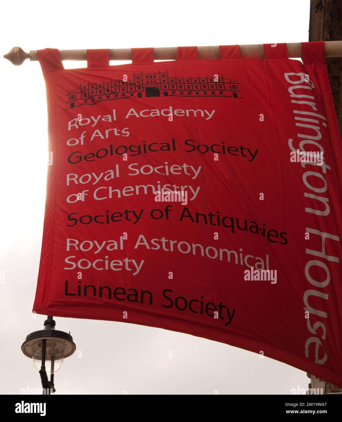 Flag outside Burlington House, listing the learned societies with offices there,  Piccadilly, Mayfair, London, UK - these include the Royal Society of Stock Photo