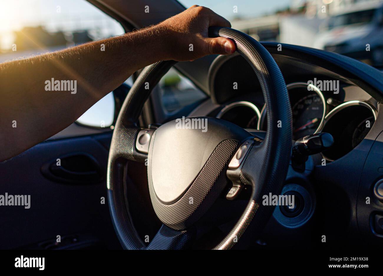 The driver keeps hands on the steering wheel of the car Stock Photo Alamy