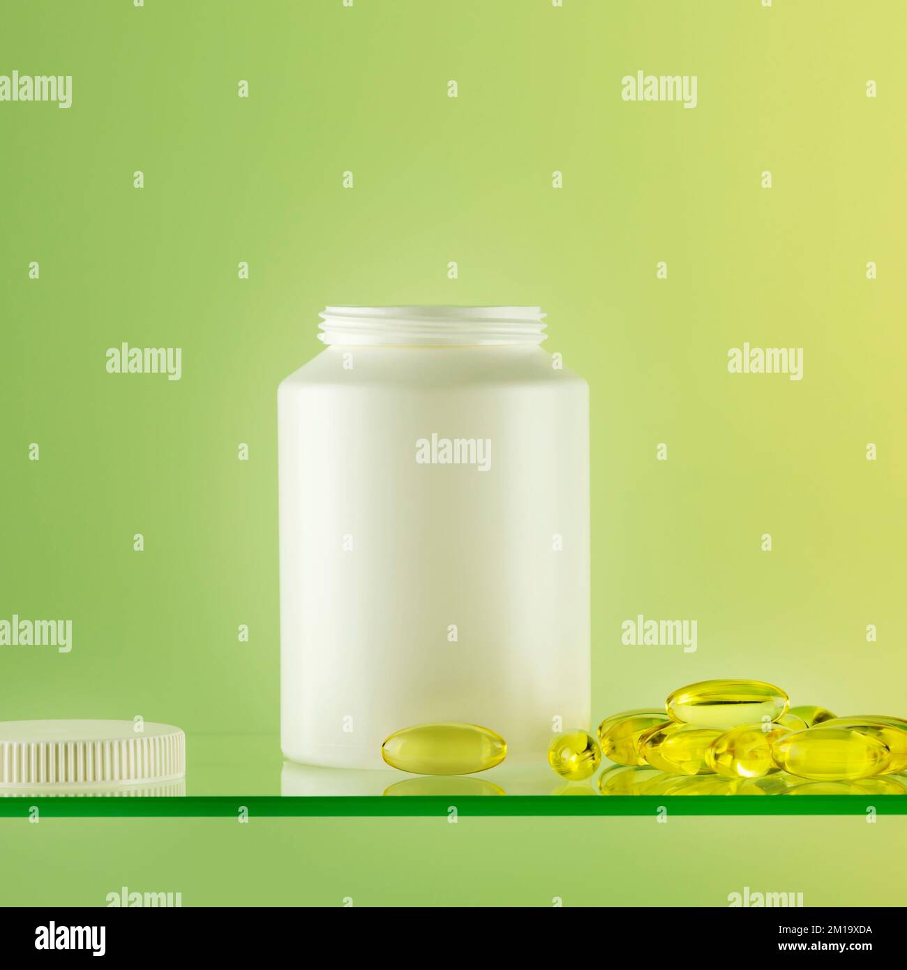 Mockup of natural bio pills, vitamins or supplements on gradient background. White bottle with healthy supplements in gel capsules. Omega 3. Organic v Stock Photo