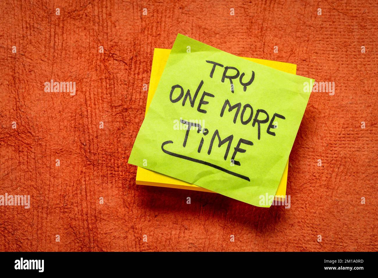 try one more time - handwritten motivational note, determination, persistence and encouragement concept Stock Photo