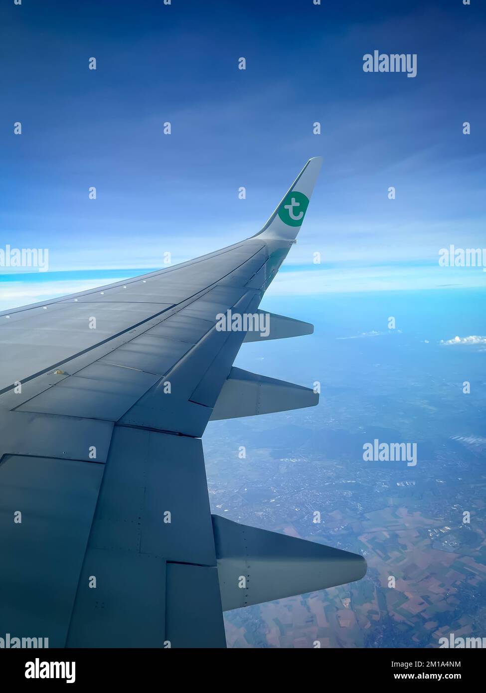 View of a wing of a Transavia airplane while flying. Stock Photo