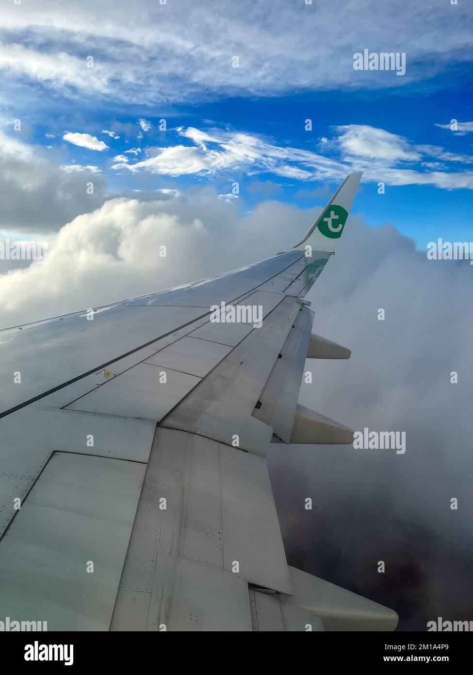 View of a wing of a Transavia airplane while flying. Stock Photo