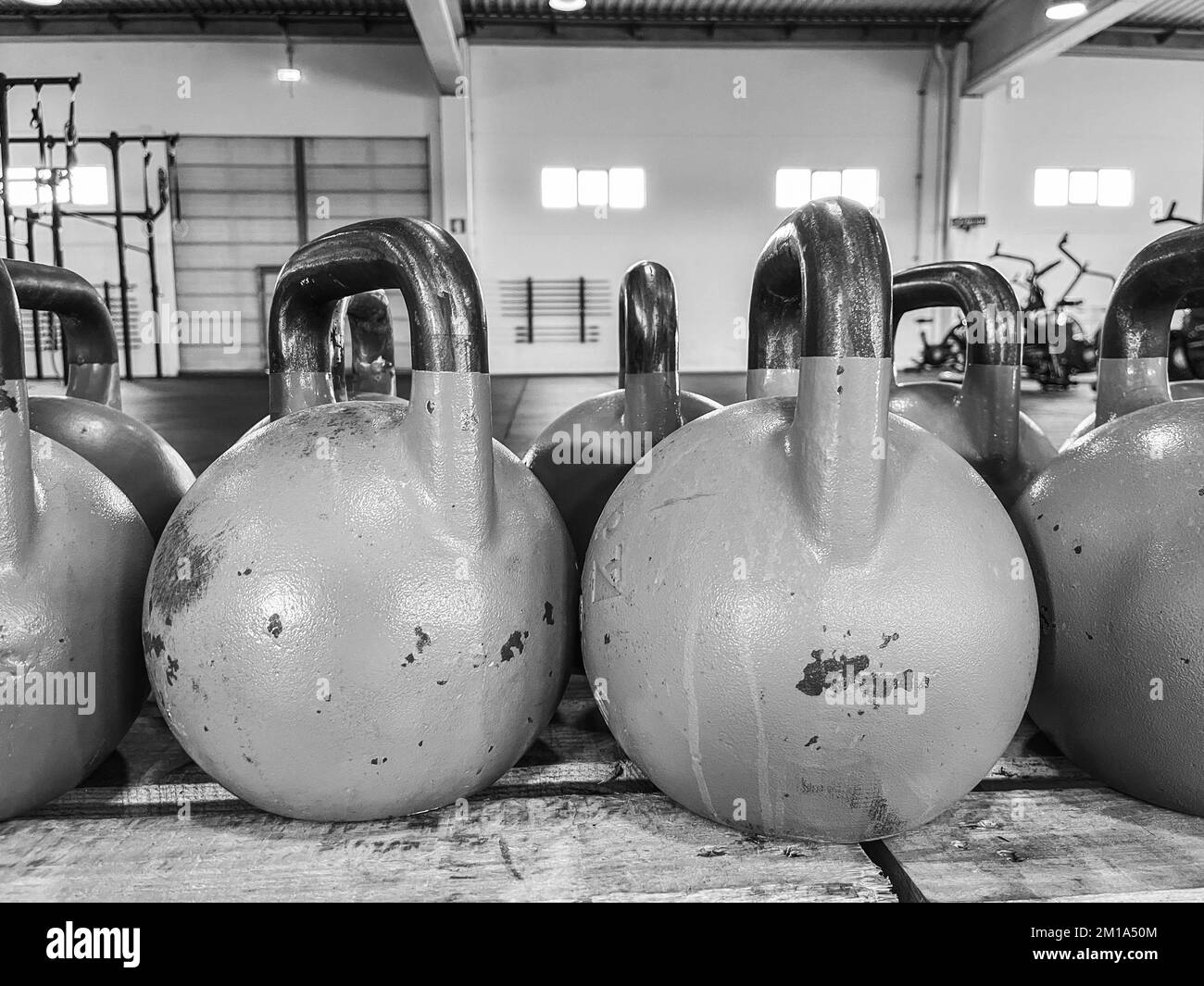 Colorful kettlebells in a gym row Stock Photo