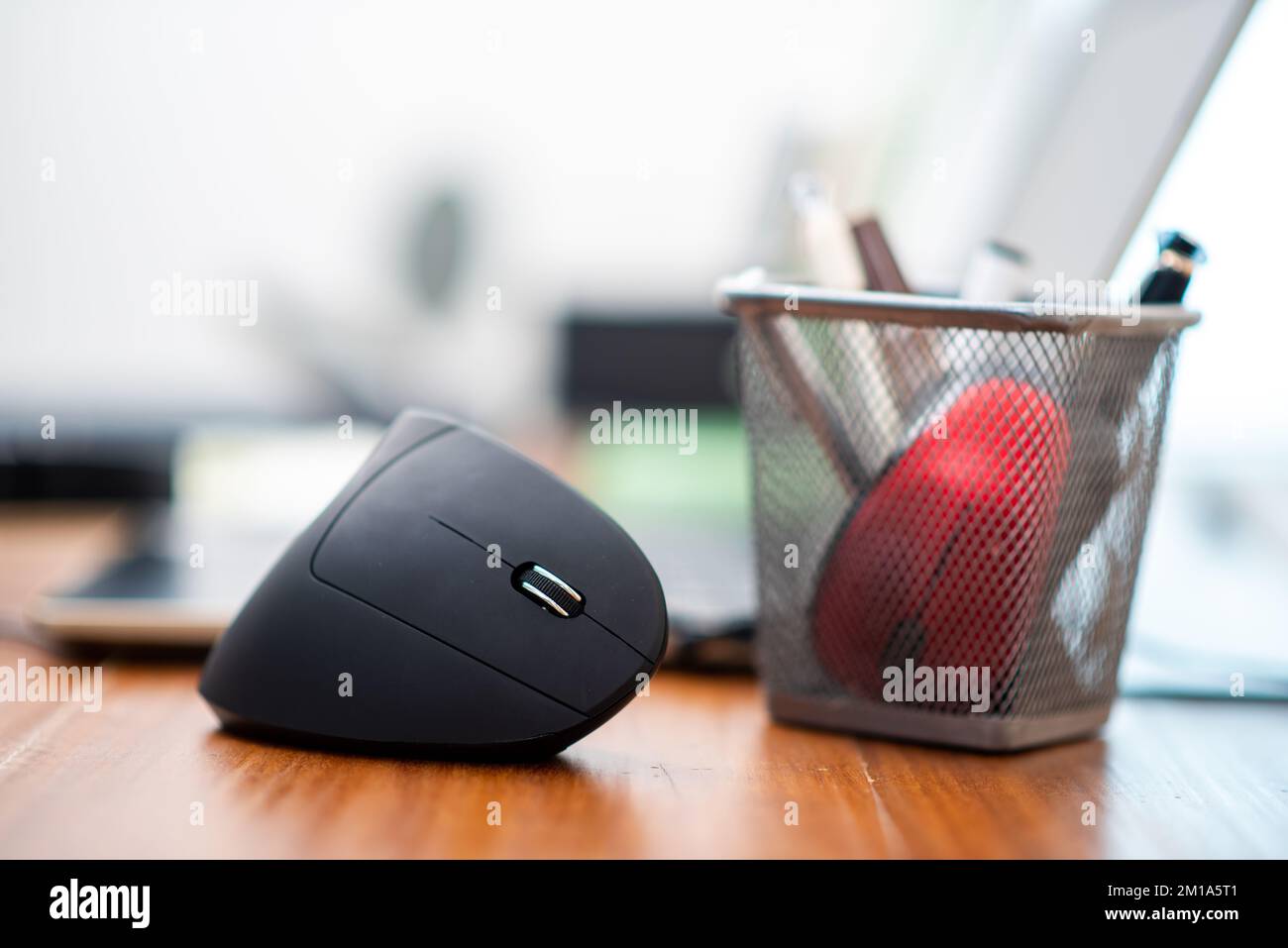 Black vertical optical computer mouse with ergonomic design. This mouse