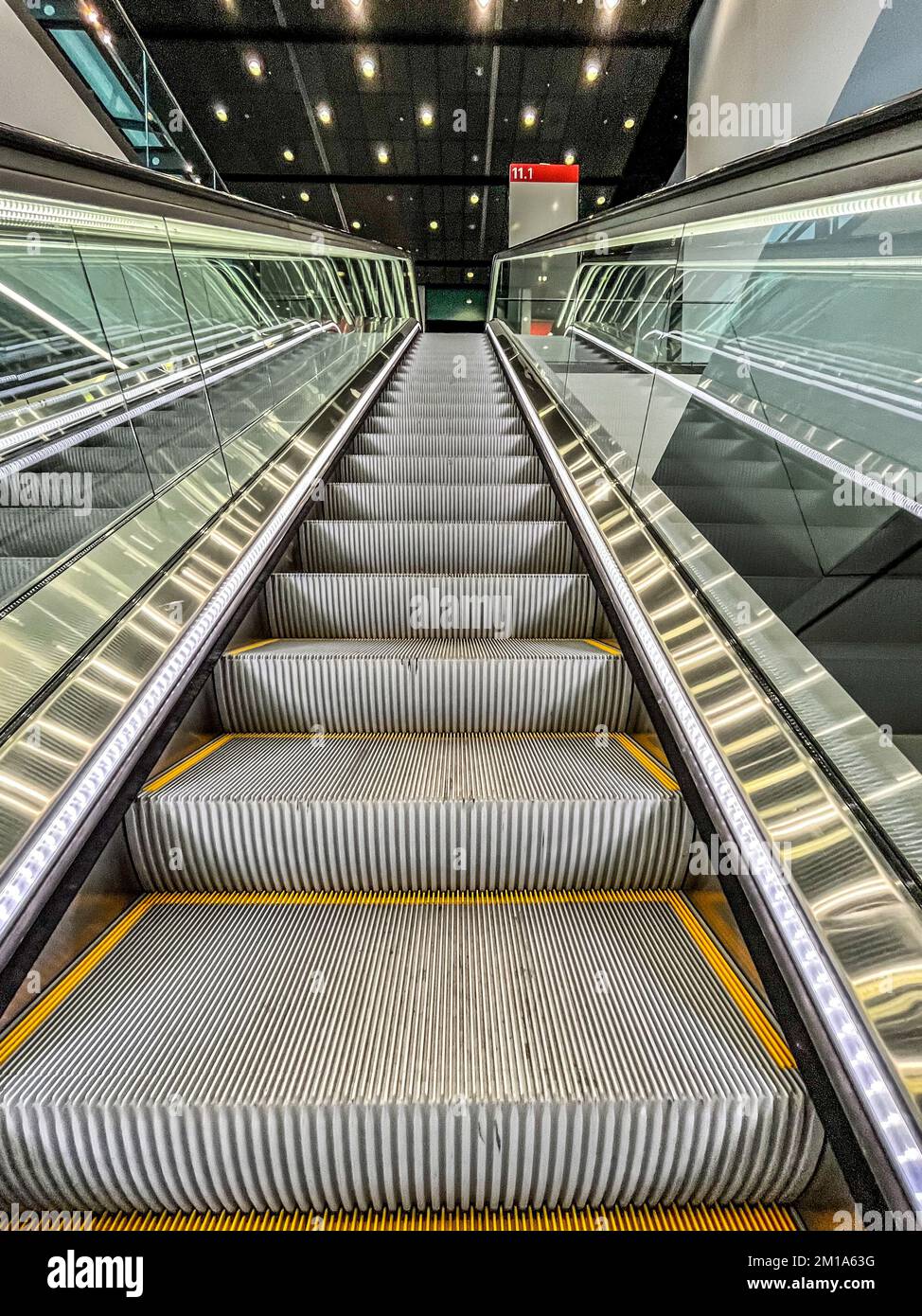 Moving up in a escalator with glass sides in a modern building Stock Photo Alamy