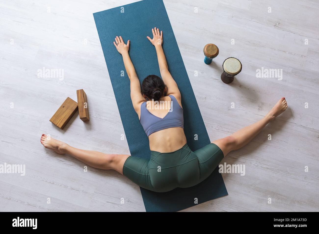 flexible little child girl in black sportswear perform transverse twine on  fly. Good stretching and gymnastics Stock Photo - Alamy