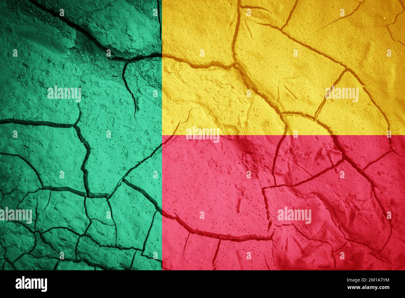 Flag of Benin. Benin symbol. Flag on the background of dry cracked earth. Benin flag with drought concept Stock Photo