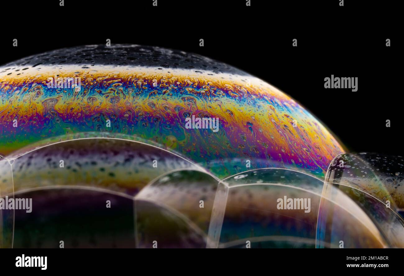 Soap bubble close up on black background. Stock Photo