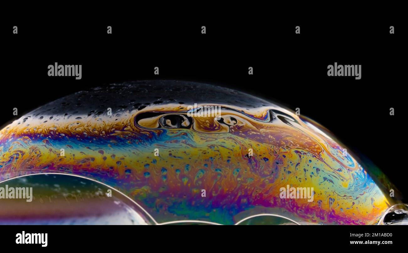 Soap bubble close up on black background. Stock Photo