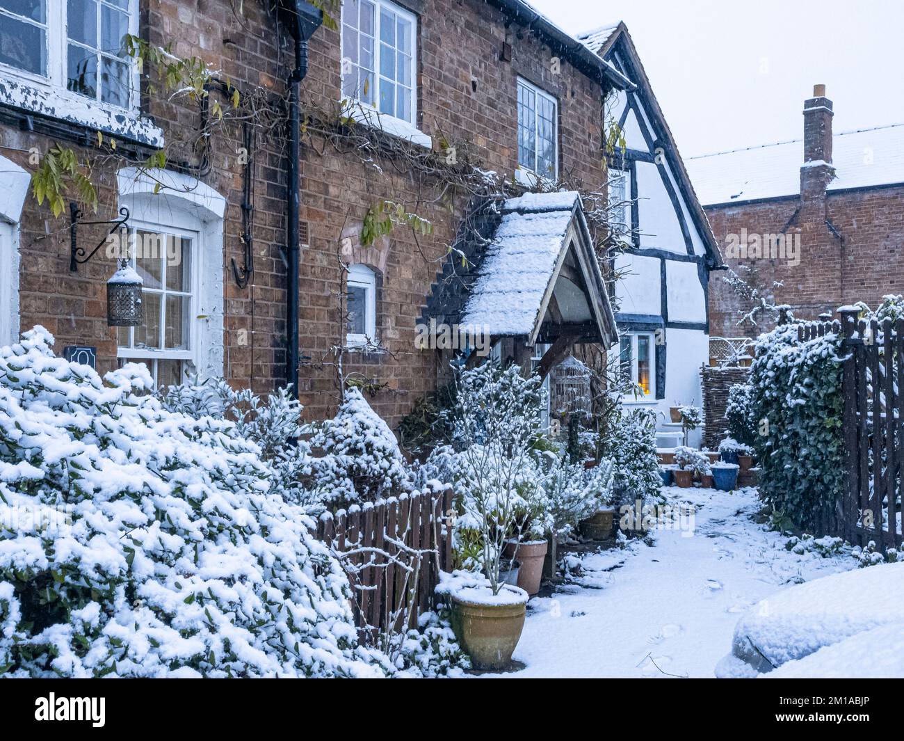 Old village cottages covered in snow, winter. Stock Photo