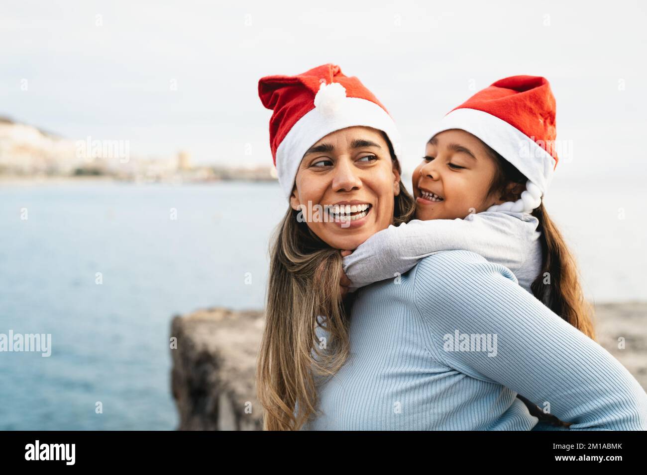 Happy Latin mother enjoying time with her child during Christmas holidays - Family and holidays concept Stock Photo