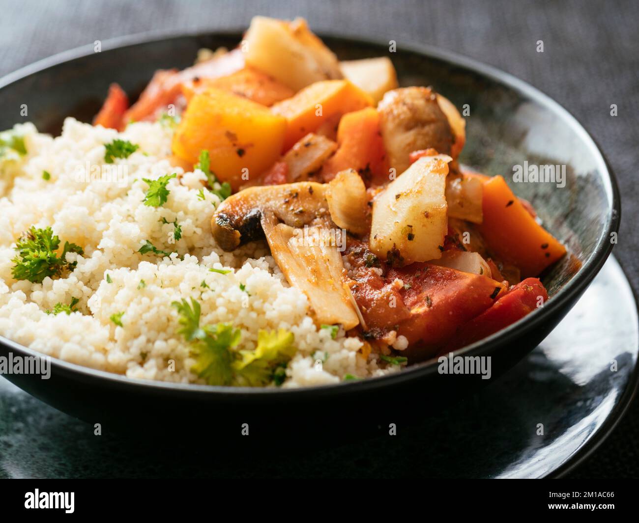 Bowl with a vegan vegetable ragu with herbed couscous Stock Photo