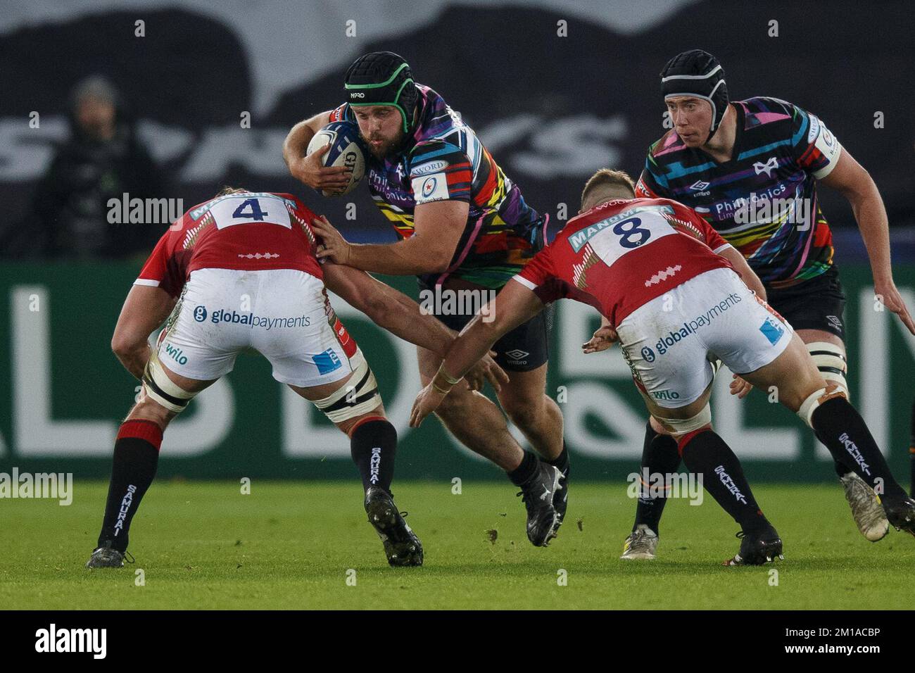 Swansea, UK. 11th Dec, 2022. Morgan Morris of Ospreys is tackled by Harry Wells and Olly Cracknell of Leicester during the Ospreys v Leicester Champions Cup rugby match. Credit: Gruffydd Thomas/Alamy Live News Stock Photo