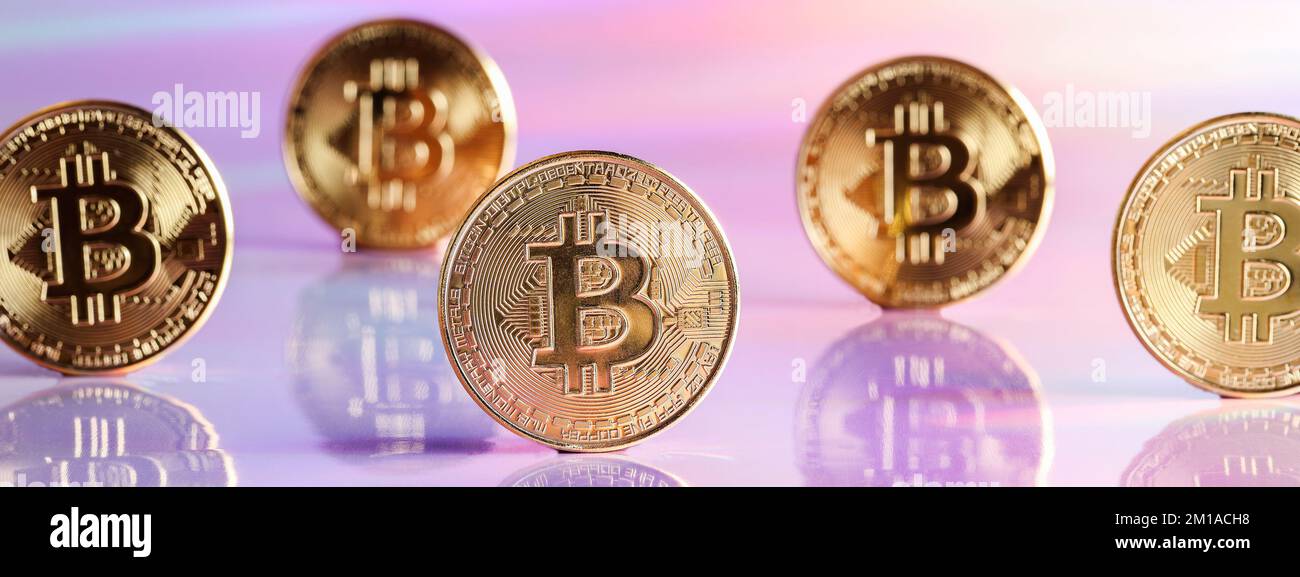 Golden bitcoin coins on holographic, neon background. digital currency, business style. Mining and trade bitcoin concept. selective focus banner Stock Photo