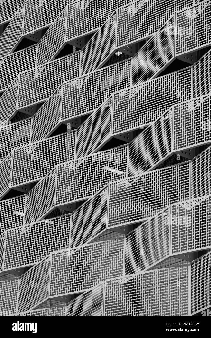 Modern steel cladding with angular geometric patterns and square holes ...