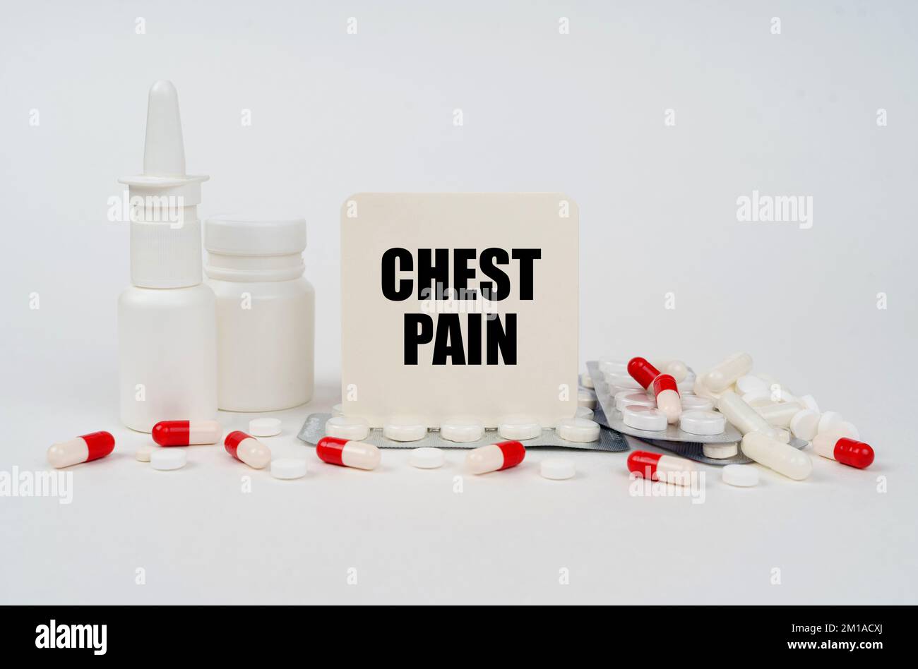 Medical concept. On a white surface, blisters, tablets, spray and a sign with the inscription - Chest pain Stock Photo