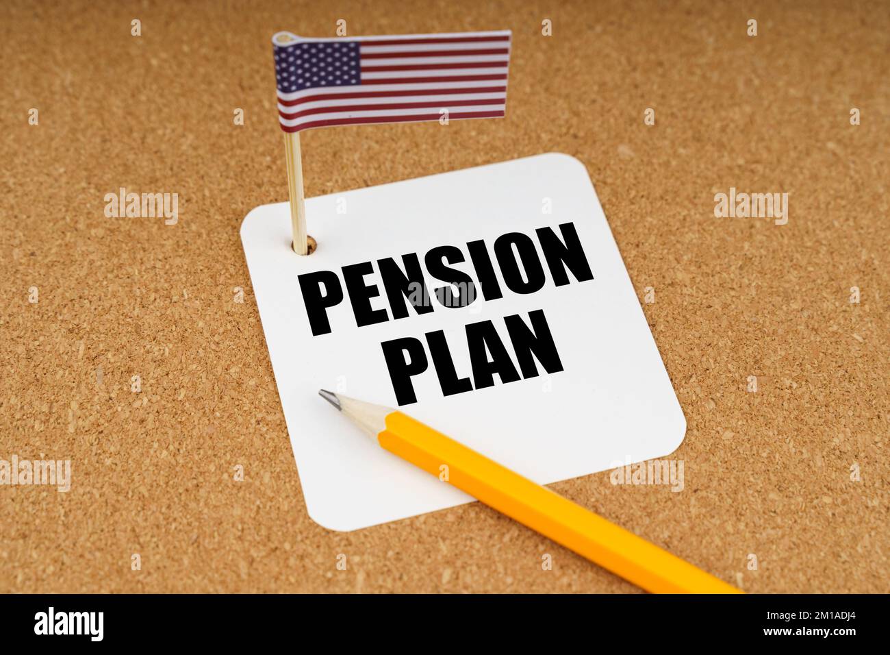 On the table is the US flag, a pencil and a sheet of paper from a notebook with the inscription - pension plan Stock Photo