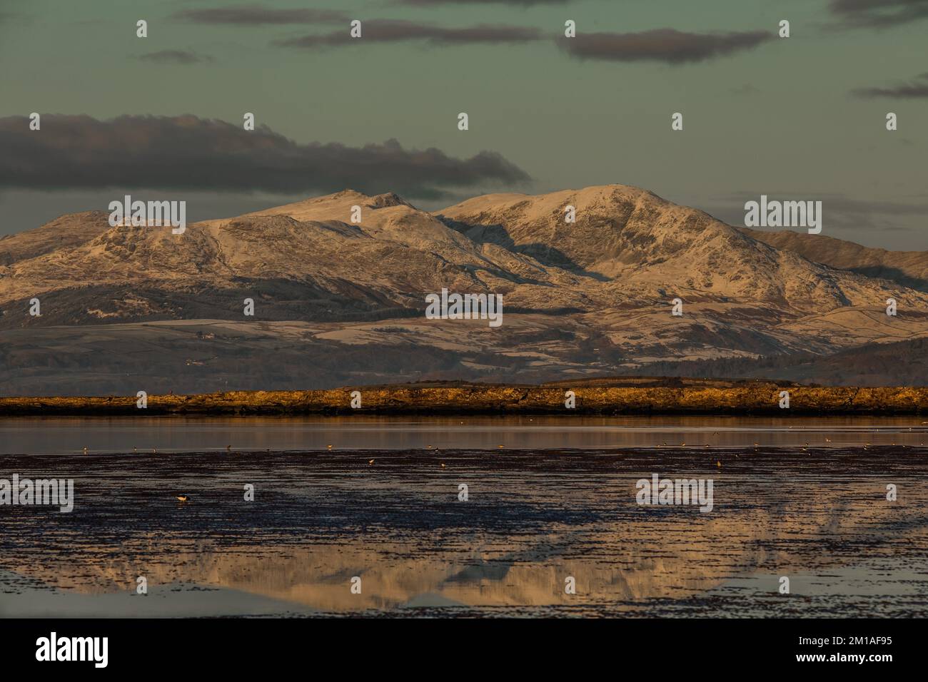 Sandscale, Cumbria. UK. 11th December 2022. UK Weather. Freezing temperatures from the dramatic Cumbrian Coast. View across the Duddon Estuary towards Dow Crag, Coniston Old Man and Wetherlam. Credit:greenburn/Alamy Live News. Stock Photo