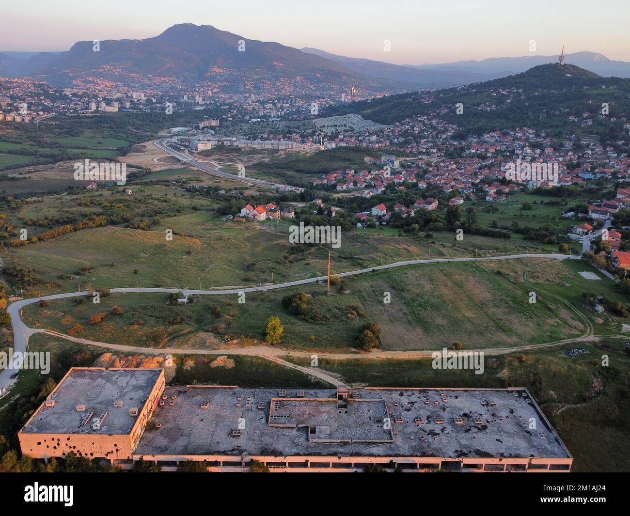 An aerial shot of Sarajevo city surrounded by hills and mountains during the daytime Stock Photo