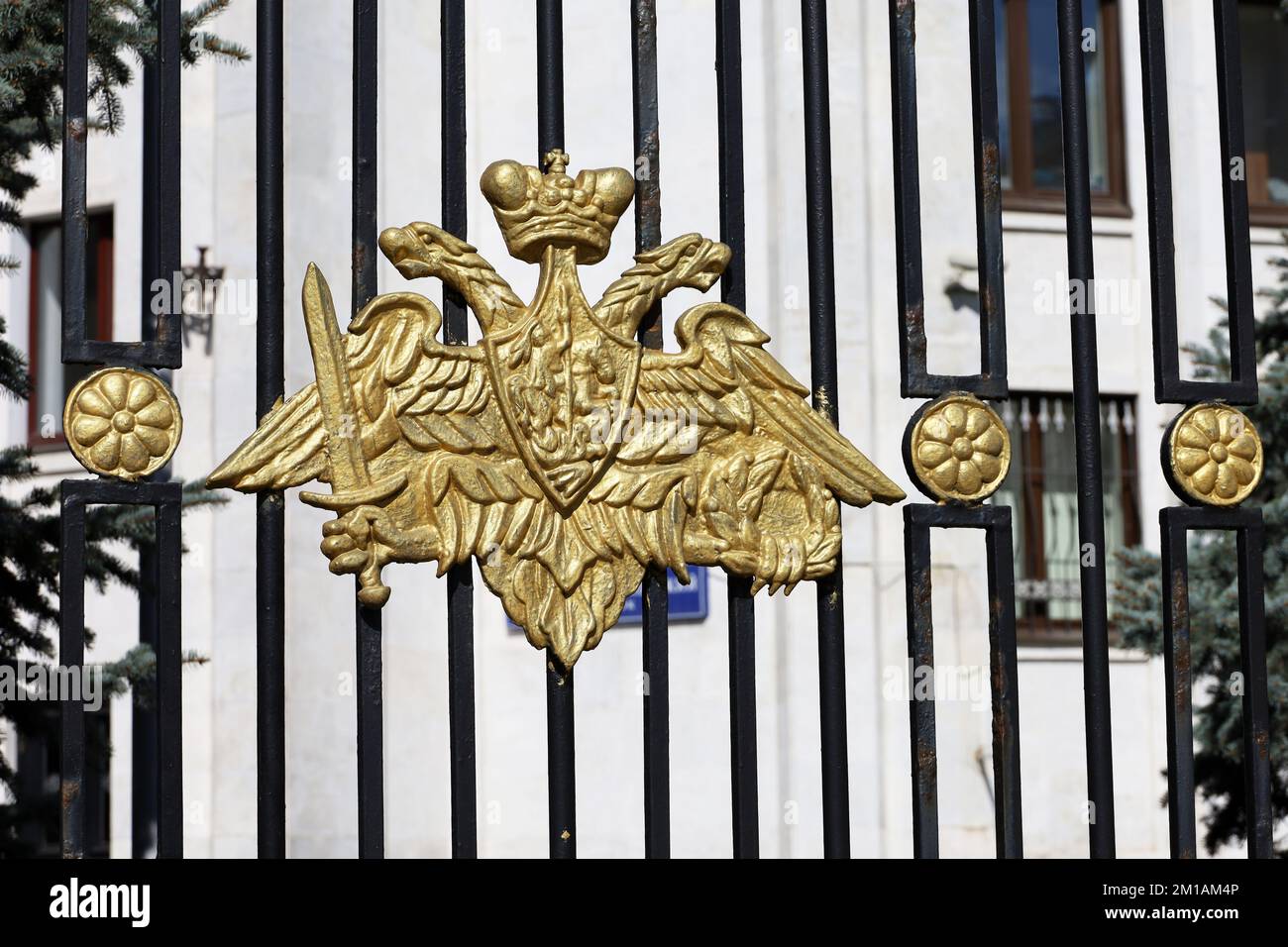 Official emblem of Defense Ministry of Russia on the metal fence, view to main office building in Moscow. Symbol of russian military, mobilization Stock Photo