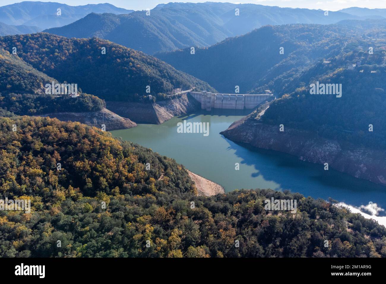 Sau reservoir dam with water levels much lower than usual due to Drought impact, water crisis, water consumption, water shortage concept. Pantà de Sau Stock Photo