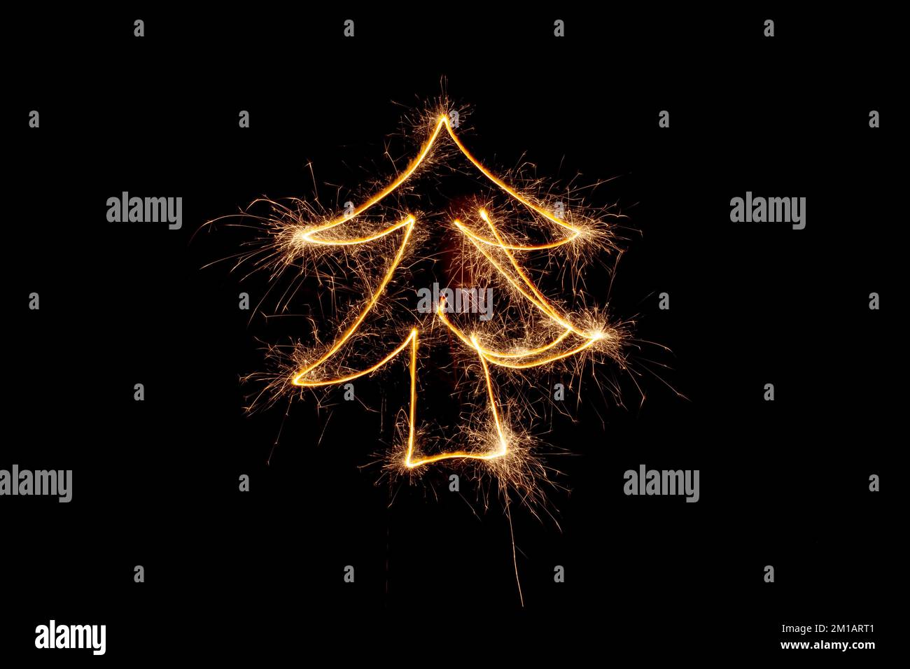 Christmas tree made by sparkler on a black background. Stock Photo