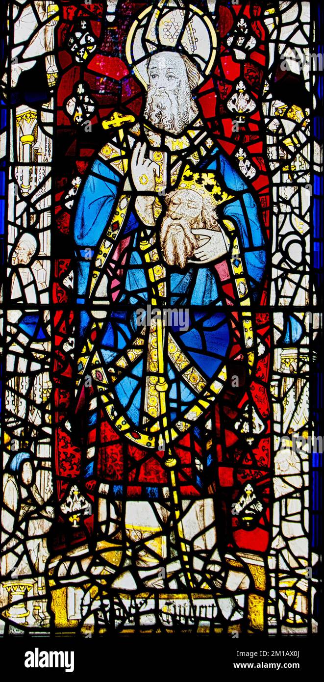 Stainedglass window of St. Cuthbert holding the head of King St