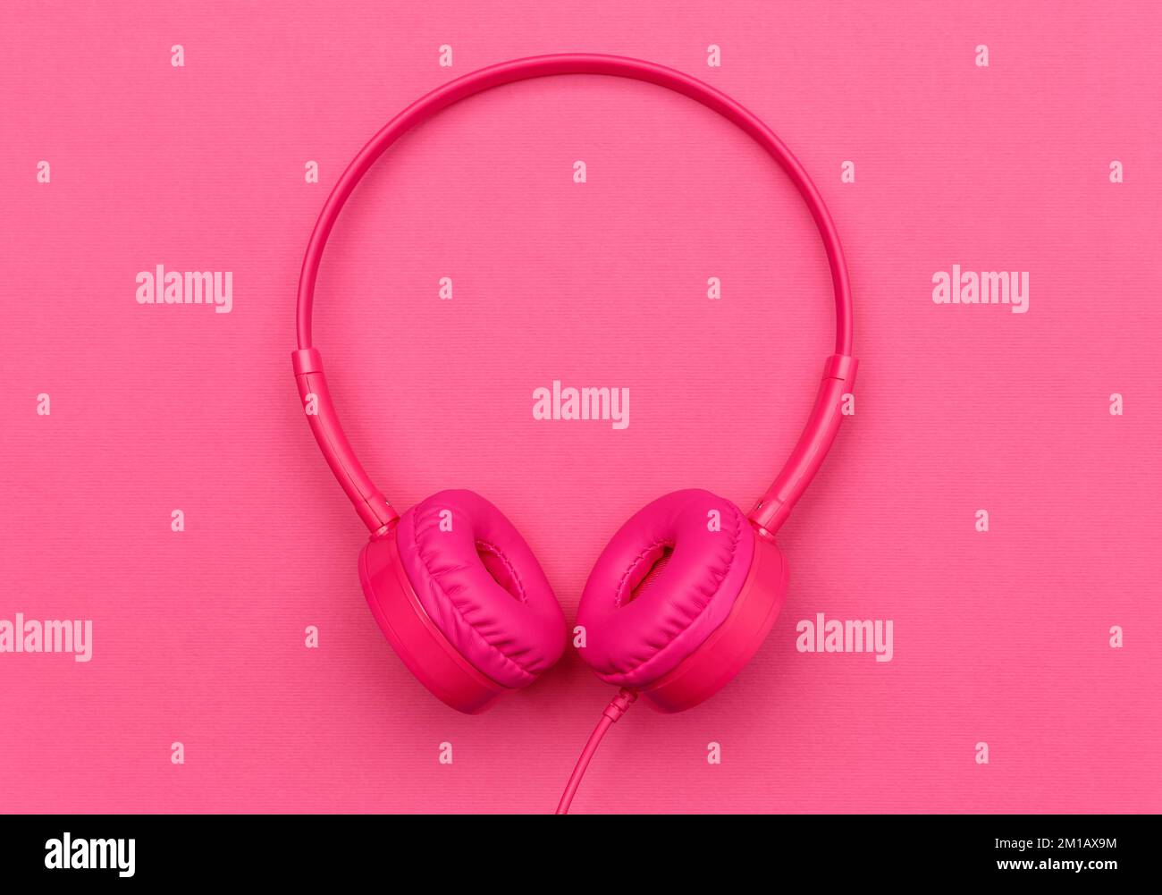 Pink headphones and on a pink background. Audiophile music concept Stock Photo Alamy