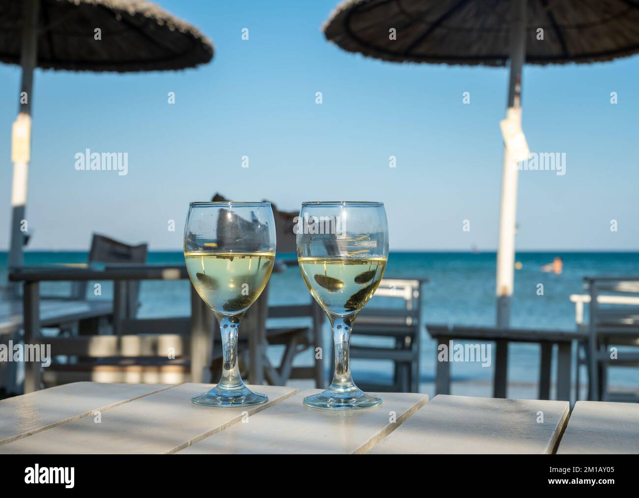 Drinking of cold white wine in beach bar, summer holidays, relax on
