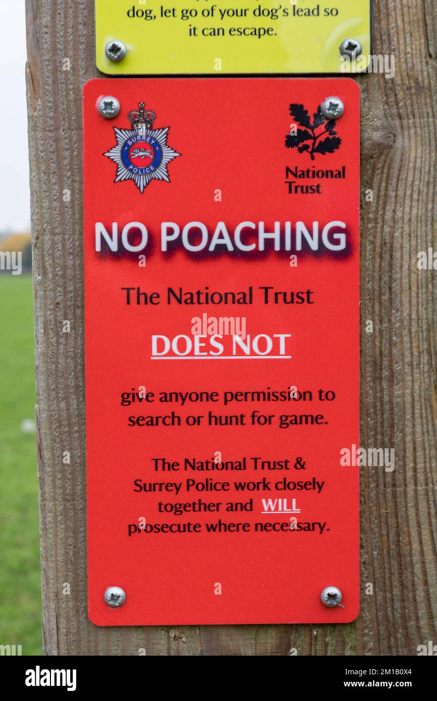 A National Trust  'No Poaching' sign on a fence post in Runnymede, Surrey, UK. Stock Photo