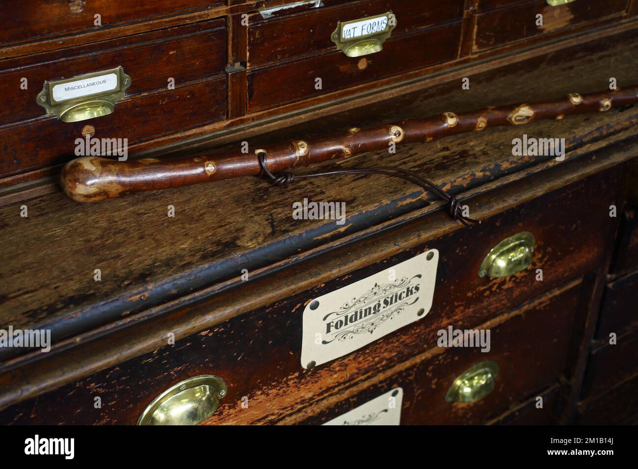 Walking stick on antique drawer at The James Smith & Son umbrella shop on New Oxford Street Stock Photo