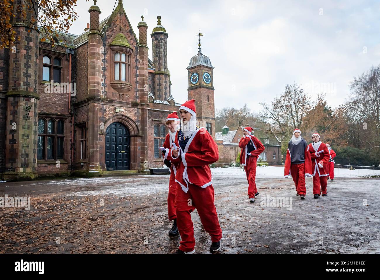 Walton Hall and Gardens, Warrington, Cheshire, England - Sunday 11 December 2022 - Warrington Disability Partnership held its second 3K Santa Dash around Walton Gardens on a slippy, snow covered circuit. Over 100 Santas took part raising money for the charity Credit: John Hopkins/Alamy Live News Stock Photo