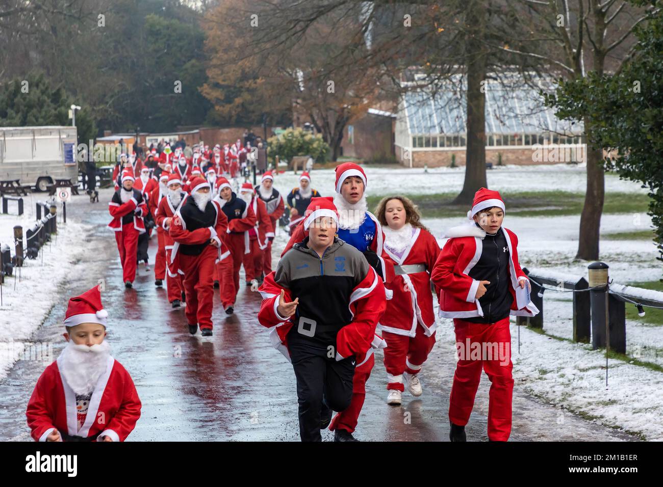 Walton Hall and Gardens, Warrington, Cheshire, England - Sunday 11 December 2022 - Warrington Disability Partnership held its second 3K Santa Dash around Walton Gardens on a slippy, snow covered circuit. Over 100 Santas took part raising money for the charity Credit: John Hopkins/Alamy Live News Stock Photo