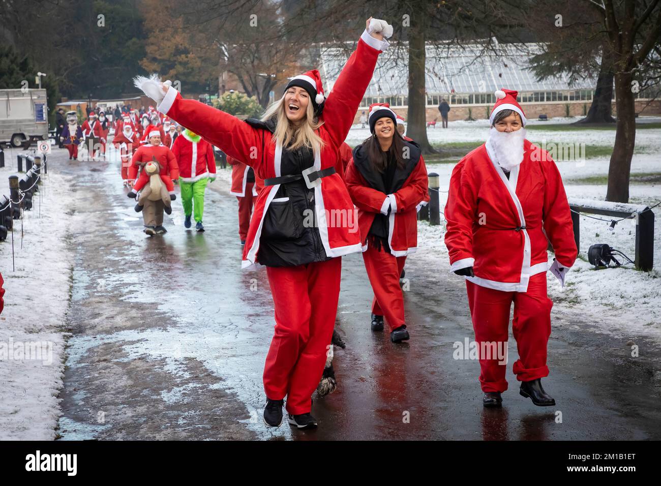 Walton Hall and Gardens, Warrington, Cheshire, England - Sunday 11 December 2022 - Warrington Disability Partnership held its second 3K Santa Dash around Walton Gardens on a slippy, snow covered circuit. Over 100 Santas took part raising money for the charity Credit: John Hopkins/Alamy Live News Stock Photo