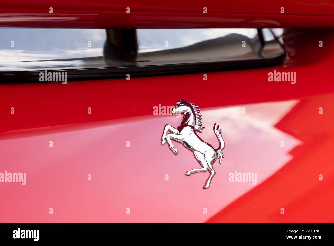 Slovenia, Ljubljana - 2 June 2022: Red Ferrari F8 Tributo Italian luxury sports car logo Stock Photo