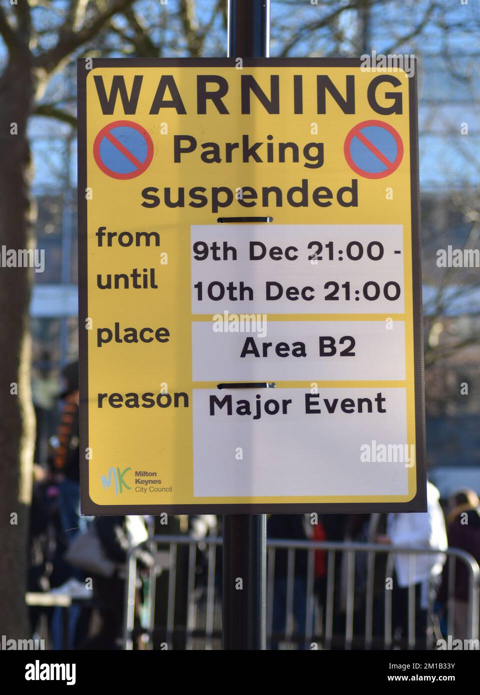 Yellow warning sign: 'Parking Suspended'. Stock Photo